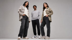 Three models wearing different pieces from the early fall essentials, posed together to show a complete autumn capsule wardrobe