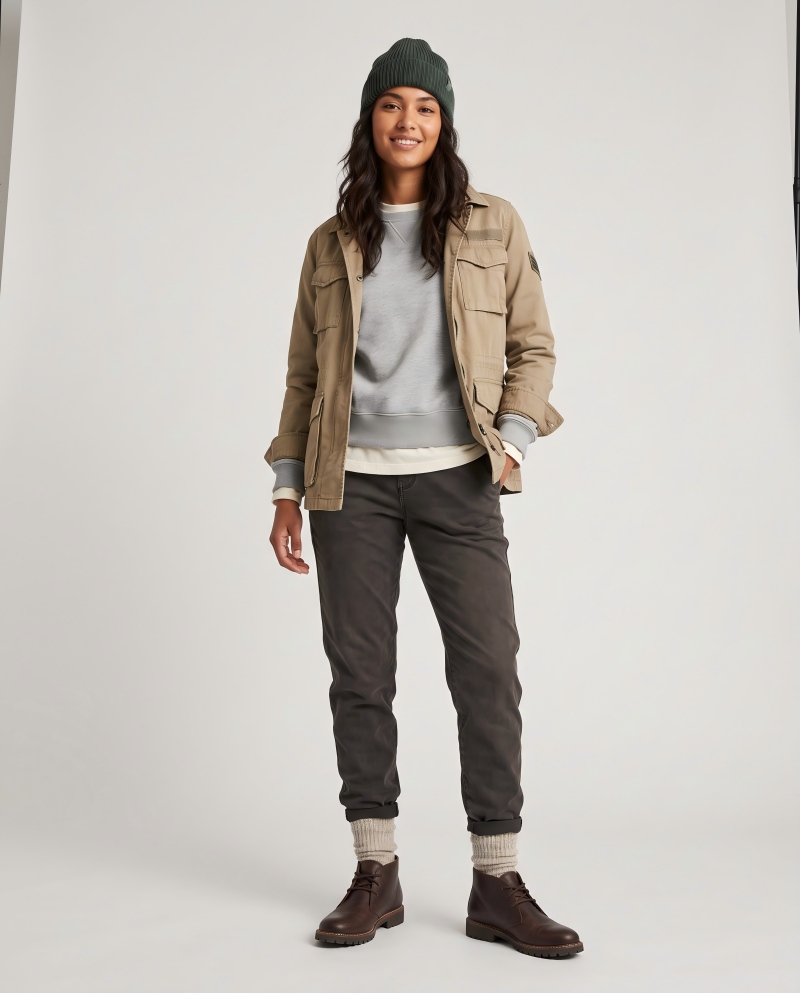 Full transition outfit on a female model with a knit beanie, rolled cuffs, and textured socks showing fall finishing details
