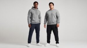 Two male models wearing a hoodie and a crewneck sweatshirt side by side, comparing silhouettes and styles