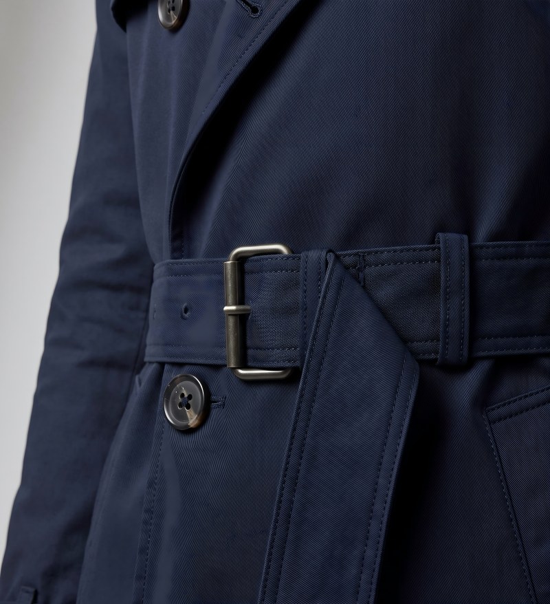 Close-up macro of a trench coat belt and structured fabric