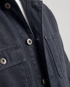 Close-up macro of a work jacket showing the twill fabric and stitching detail