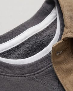 Close-up macro of a kids' cotton crewneck sweatshirt showing the soft fabric texture