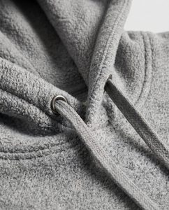 Close-up macro of a fleece hoodie showing the fabric and drawstring detail