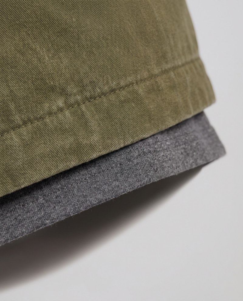 Close-up macro of layered hems with the inner layer peeking below the outer
