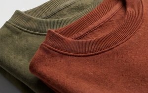 Close-up macro of matching crewneck sweatshirts showing the fabric texture