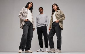 Three models wearing different pieces from the early fall essentials, posed together to show a complete autumn capsule wardrobe