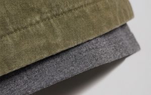 Close-up macro of layered hems with the inner layer peeking below the outer